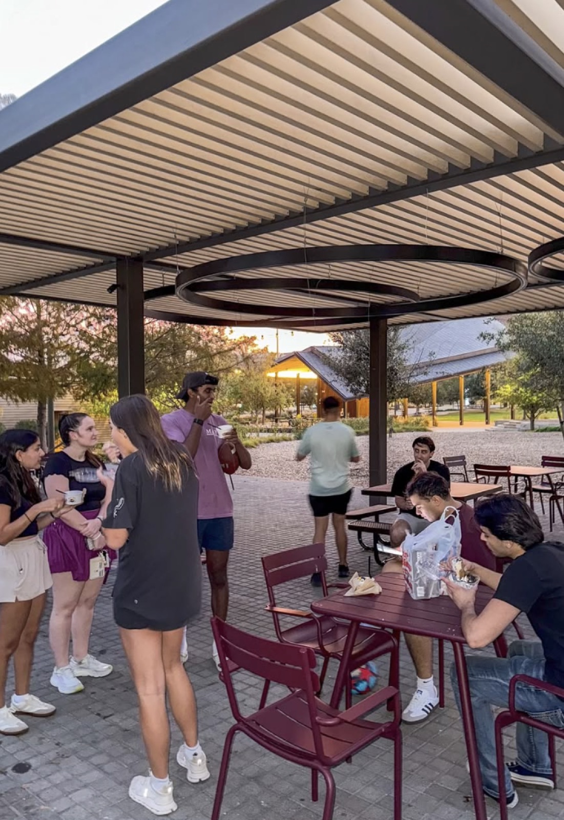 Members hanging out at an outdoor pavilion